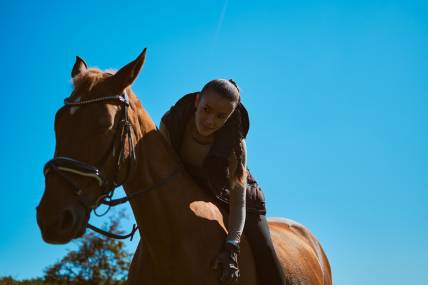 Anna Riding Horse Leaning Forward